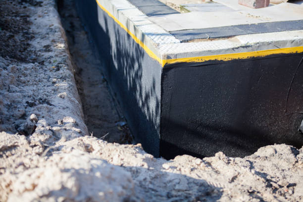 Professional Basement Waterproofing technician working in Carrollton, KY